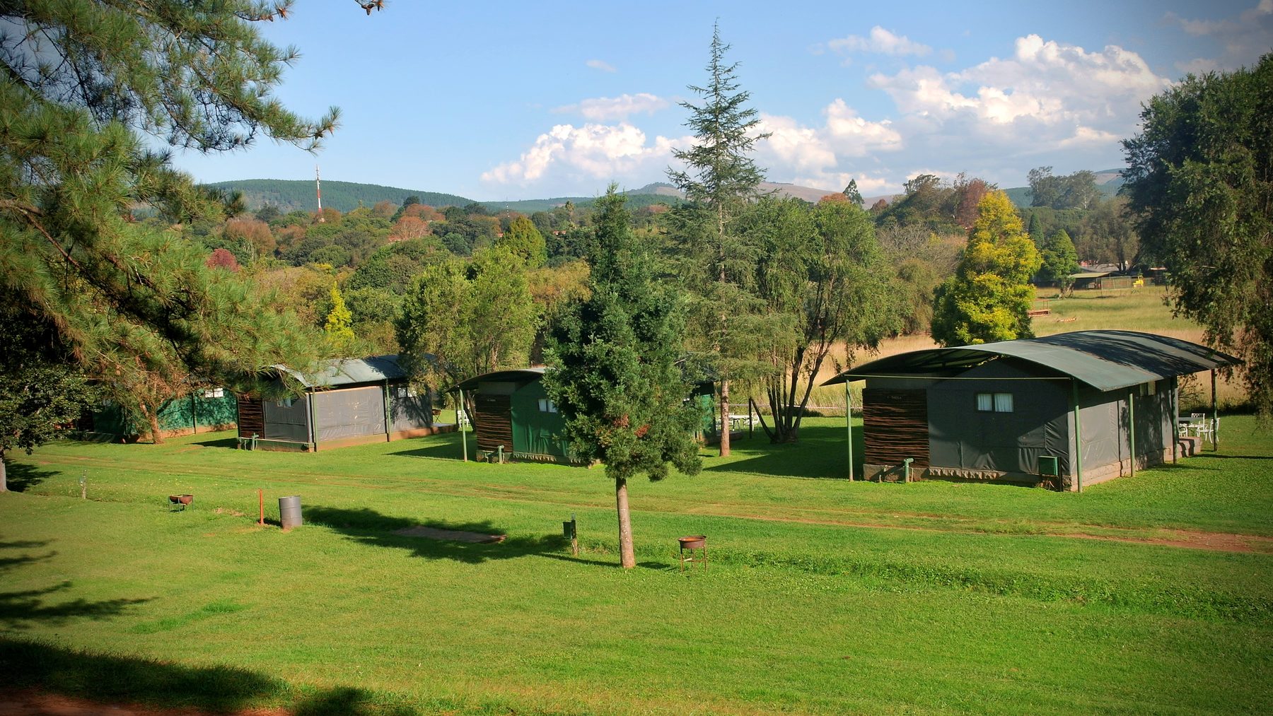 Safari tents spaced out along the grassed grounds at Sabie River Camp