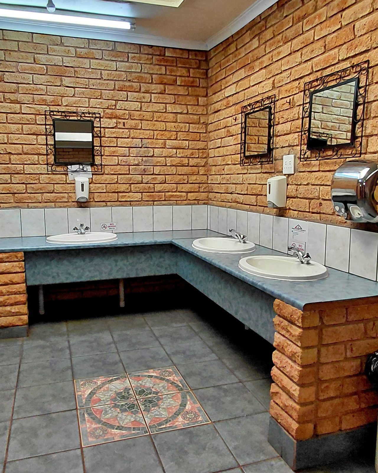 Men's bathroom with urinals and basins