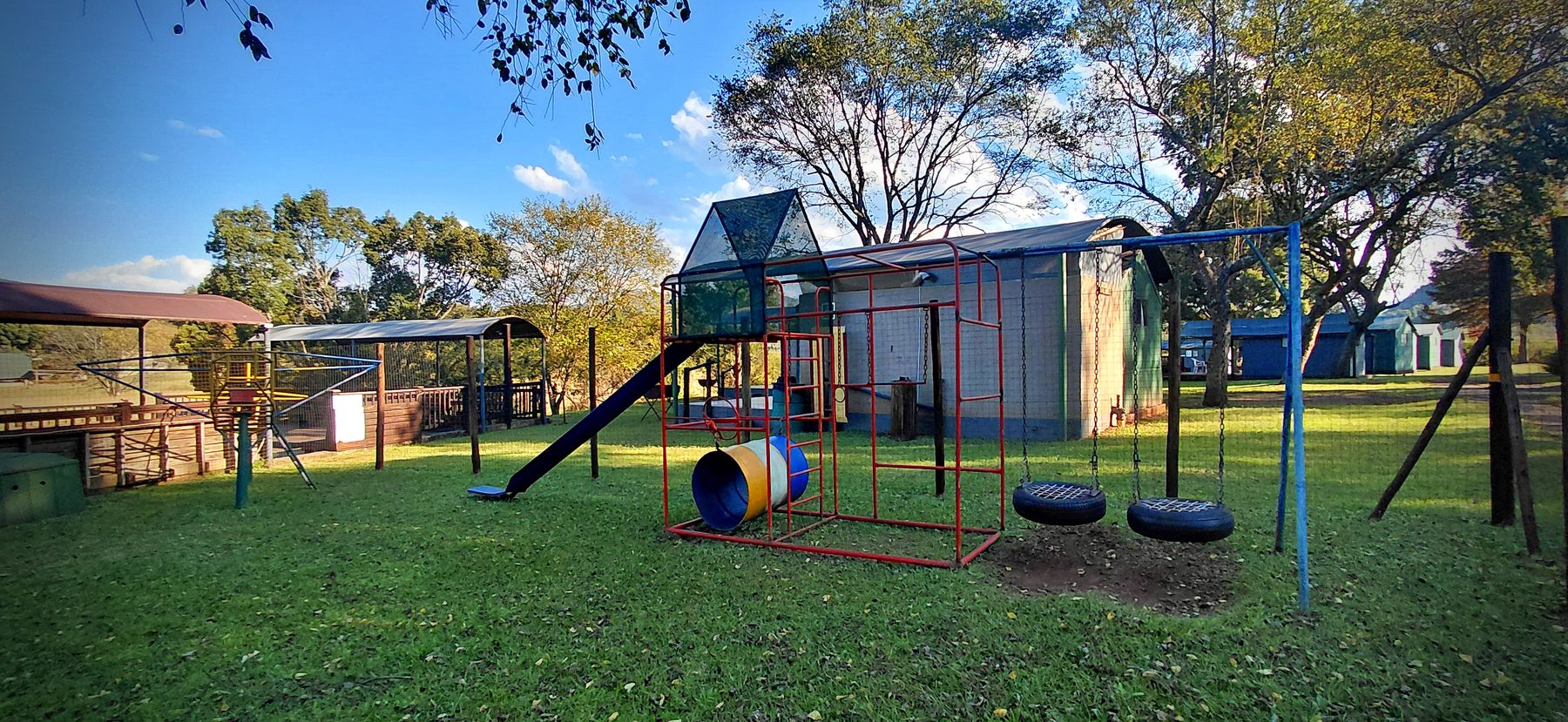 Children's play area with swings and jungle gym