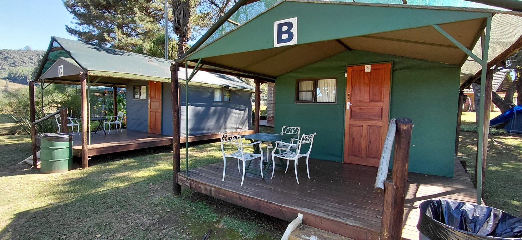Outside view of the four sleeper tents on stilts with private wooden deck and patio set