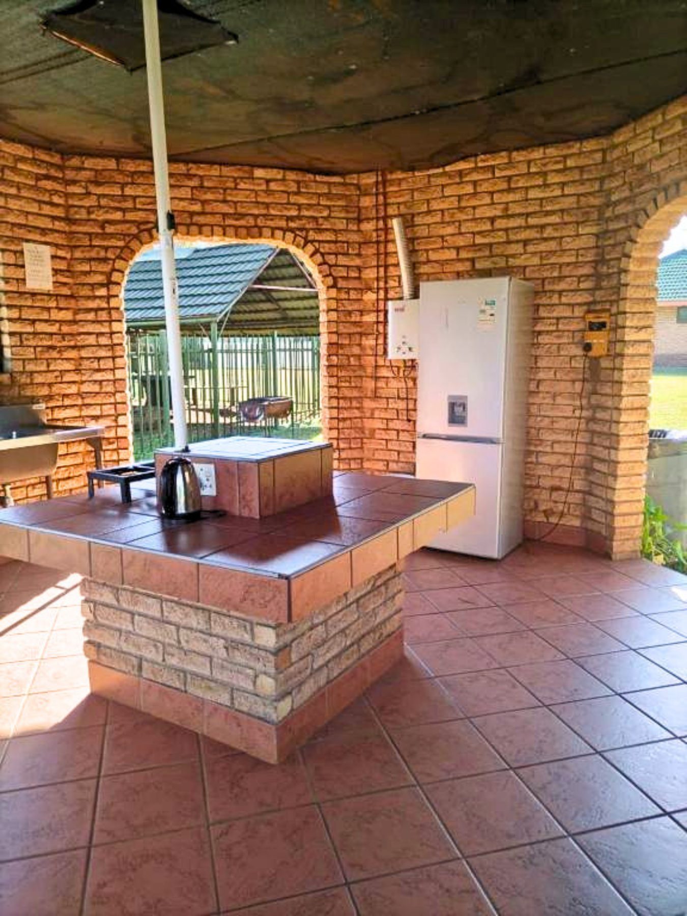 Communal kitchen and braai area under the brick lapa